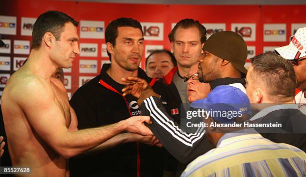 Juan Carlos Gomez of Cuba pushes Vitali Klitschko of Ukraine after the weigh in at the Karstadt Sport shop on March 20, 2009 in Stuttgart, Germany....