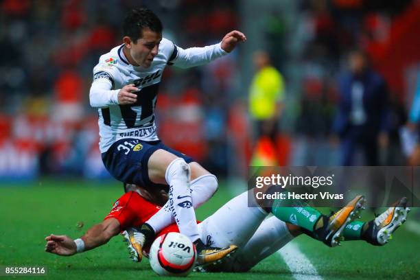 Fernando Uribe of Toluca struggles for the ball with Alan Mozo of Pumas during the 11th round match between Toluca and Pumas UNAM as part of the...