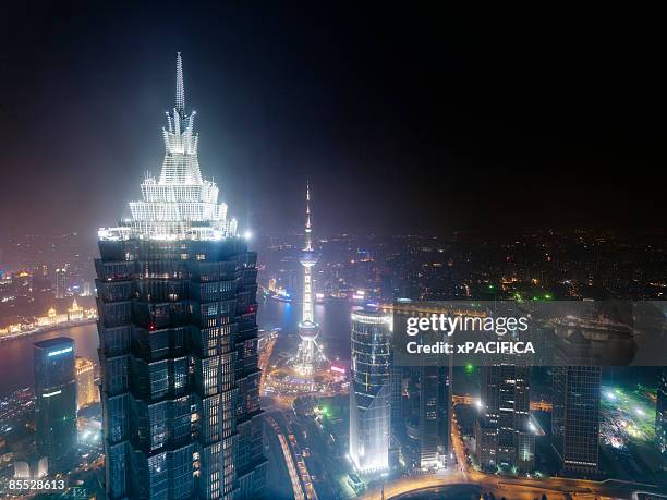 the illuminated roof of the jin mao tower - jin mao tower stock pictures, royalty-free photos & images