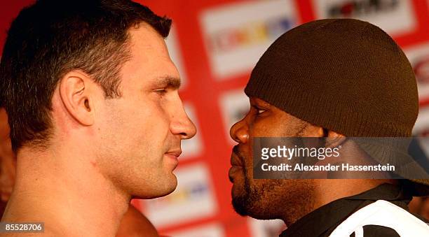 Juan Carlos Gomez of Cuba poses with Vitali Klitschko of Ukraine, after the weigh in at the Karstadt Sport shop on March 20, 2009 in Stuttgart,...