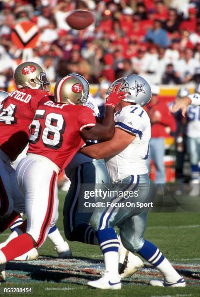 Mark Tuinei of the Dallas Cowboys in action against Todd Kelly of the San Francisco 49ers during an NFL football game November 13, 1994 at...