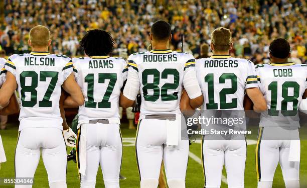 Green Bay Packers players link arms during the singing of the national anthem before the game against the Chicago Bears at Lambeau Field on September...