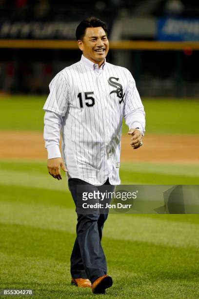 Former Chicago White Sox player Tadahito Iguchi smiles after throwing out a ceremonial first pitch before the game between the Chicago White Sox and...