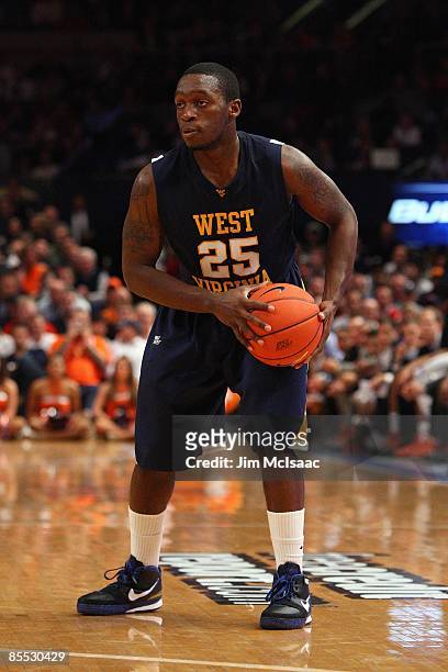 Darryl Bryant of the West Virginia Mountaineers holds the ball against the Syracuse Orange during the semifinal round of the Big East Tournament at...