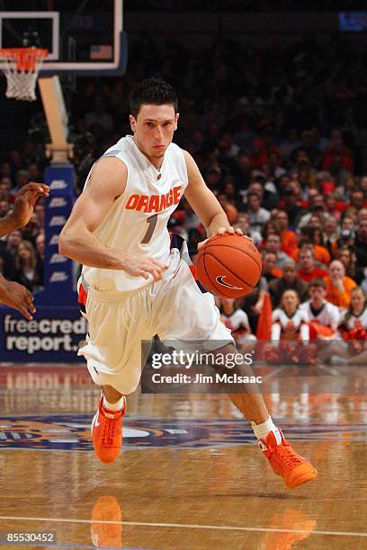 Andy Rautins of the Syracuse Orange dribbles against the West Virginia Mountaineers during the semifinal round of the Big East Tournament at Madison...