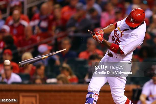 Dexter Fowler of the St. Louis Cardinals breaks his bat while hitting an RBI ground out against the Chicago Cubs in the sixth inning at Busch Stadium...