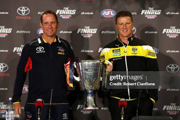 Crows coach Don Pyke and Tigers coach Damien Hardwick pose with the AFL Premiership Cup during the 2017 AFL Grand Final press conference on September...