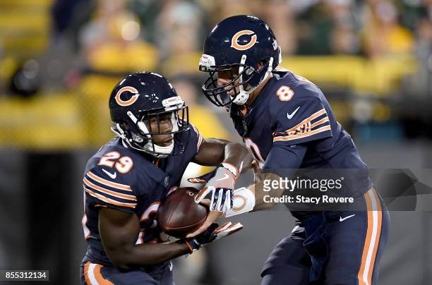 Mike Glennon of the Chicago Bears hands the ball off to Tarik Cohen in the first quarter against the Green Bay Packers at Lambeau Field on September...
