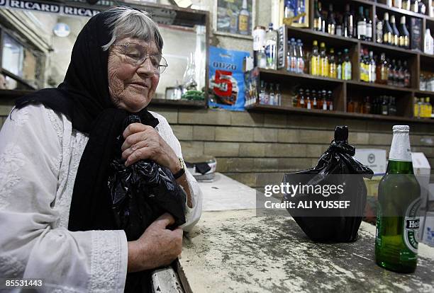 British national Bridget Jones buys wine and beer from a shop in central Baghdad on March 20, 2009. When Jones leaves her apartment in London's leafy...