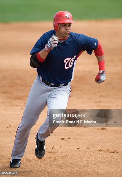 Alex Cintron of the Washington Nationals runs to third base against the Florida Marlins during a spring training game at Roger Dean Stadium on March...