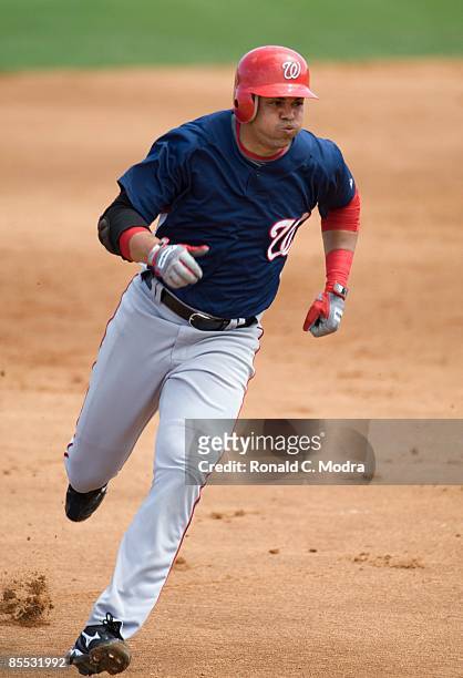Alex Cintron of the Washington Nationals runs to third base against the Florida Marlins during a spring training game at Roger Dean Stadium on March...