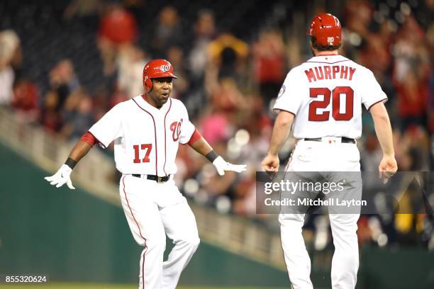 Alejandro De Aza of the Washington Nationals celebrates getting a game-winning hit with Daniel Murphy to score Anthony Rendon during a baseball game...