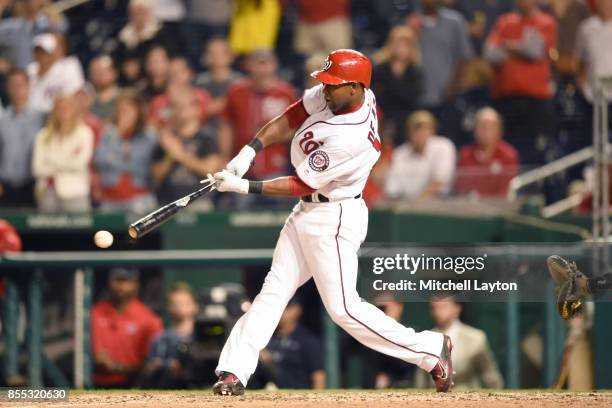 Alejandro De Aza of the Washington Nationals gets a game-winning hit to score Anthony Rendon in the ninth inning during a baseball game against the...