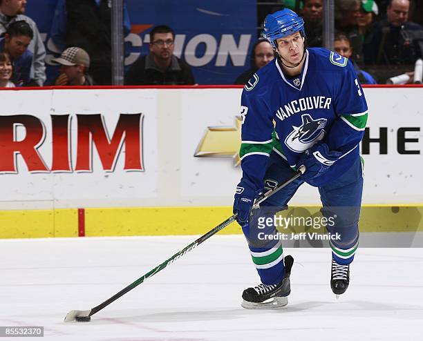 Kevin Bieksa of the Vancouver Canucks skates up ice with the puck during the game against the Colorado Avalanche at General Motors Place on March 15,...