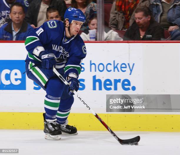 Ryan Johnson of the Vancouver Canucks skates up ice with the puck during the game against the Colorado Avalanche at General Motors Place on March 15,...