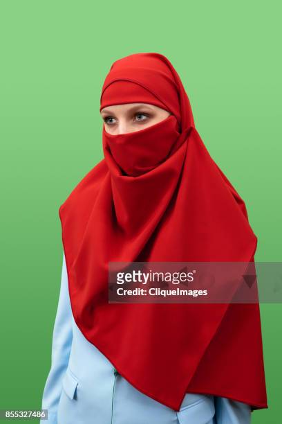 woman in beautiful red niqab - cliqueimages stock-fotos und bilder