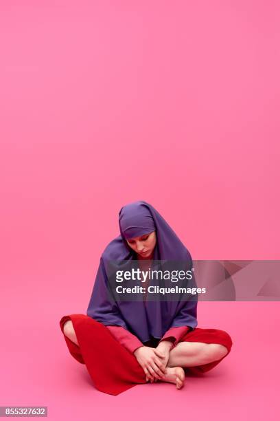sad woman in hijab - cliqueimages stock-fotos und bilder