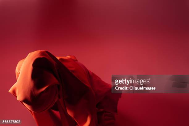 mysterious woman in red headscarf - cliqueimages stock-fotos und bilder