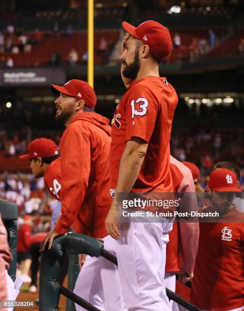 The St. Louis Cardinals' Matt Carpenter, middle, and Adam Wainwright, second from left, react after Chicago Cubs center fielder Leonys Martin robbed...