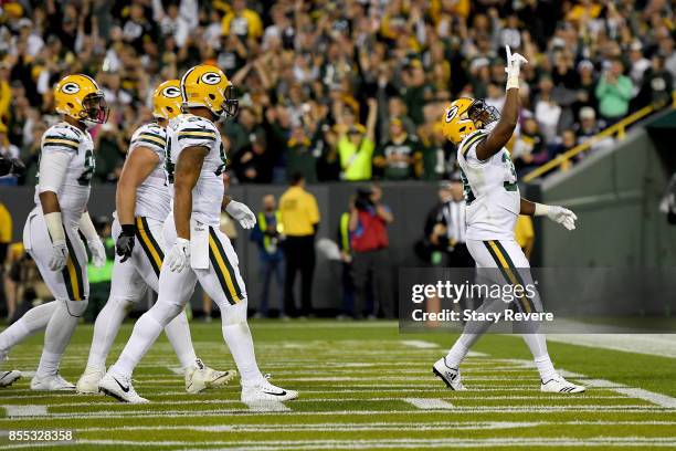 Aaron Jones of the Green Bay Packers celebrates after scoring a touchdown in the second quarter against the Chicago Bears at Lambeau Field on...