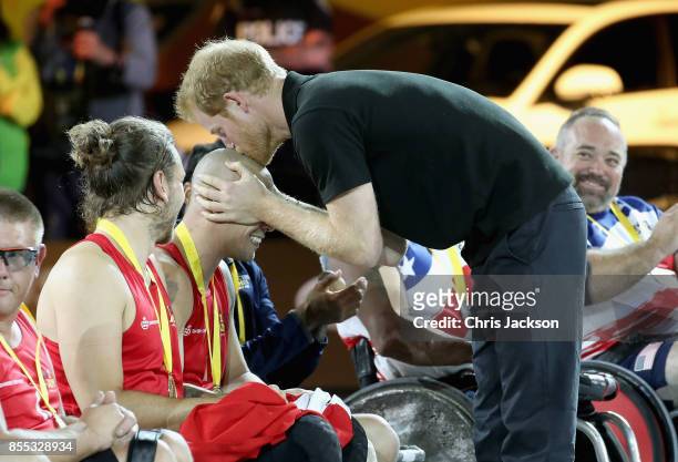 Prince Harry kisses a Norwegian Competitor after presenting him with a gold medal in the wheelchair rugby at the Mattany Athletics Centre on...