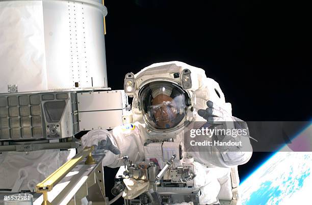 In this handout photo provided by NASA, Astronaut Richard Arnold, STS-119 mission specialist, participates in the mission's first scheduled session...