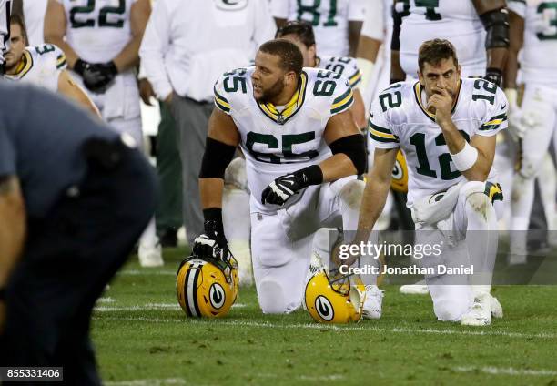 Lane Taylor and Aaron Rodgers of the Green Bay Packers kneel while Davante Adams is attended to after being injured in the third quarter against the...