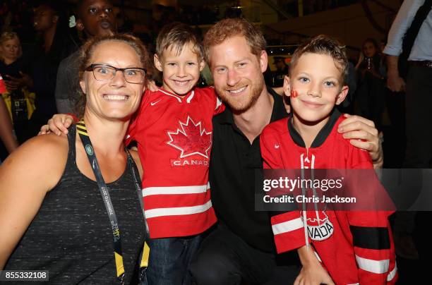 Prince Harry poses with a Canadian family after the wheelchair rugby at the Mattany Athletics Centre on September 28, 2017 in Toronto, Canada.