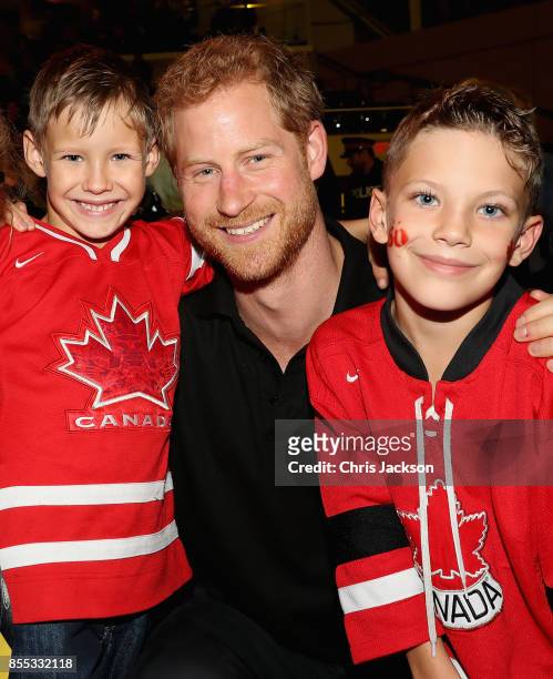 Prince Harry poses with a Canadian family after the wheelchair rugby at the Mattany Athletics Centre on September 28, 2017 in Toronto, Canada.