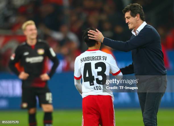 Jens Todt of Hamburg shakes hands with Tatsuya Ito of Hamburg during the Bundesliga match between Bayer 04 Leverkusen and Hamburger SV at BayArena on...