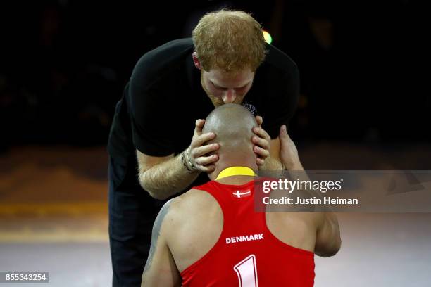 Prince Harry congratulates gold medalist Maurice Manuel of Denmark after defeating Team United Kingdom in the Wheelchair Rugby Final Gold match...