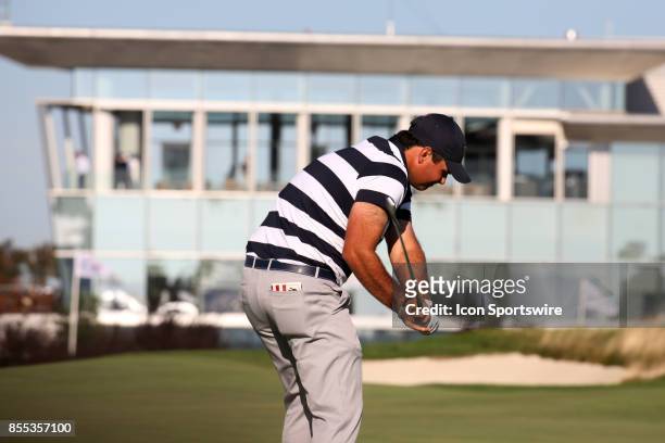 Golfer Patrick Reed hits a shot on the 14th hole during the first round of the Presidents Cup on September 28 at Liberty National Golf Club in Jersey...