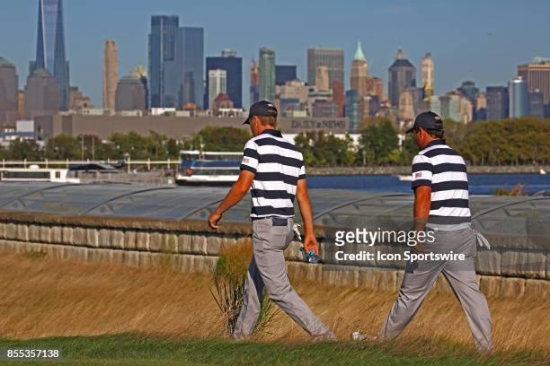 Golfers Jordan Spieth and Patrick Reed walk the 14th hole during the first round of the Presidents Cup on September 28 at Liberty National Golf Club...