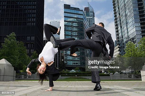 businesspeople practising capoeira - businesswoman handstand stock pictures, royalty-free photos & images