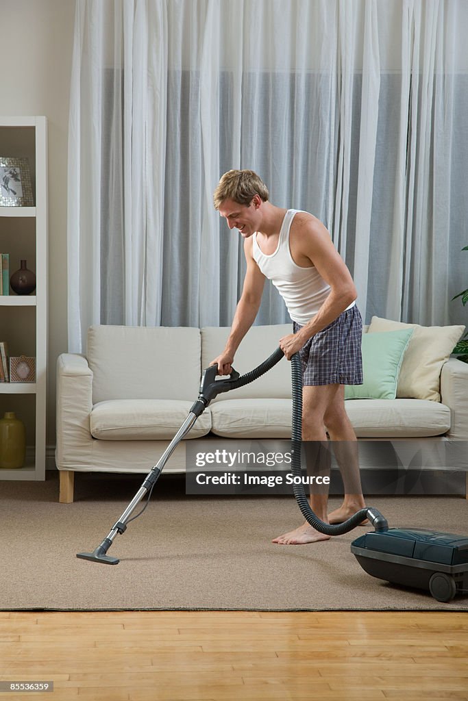 A man vacuum cleaning