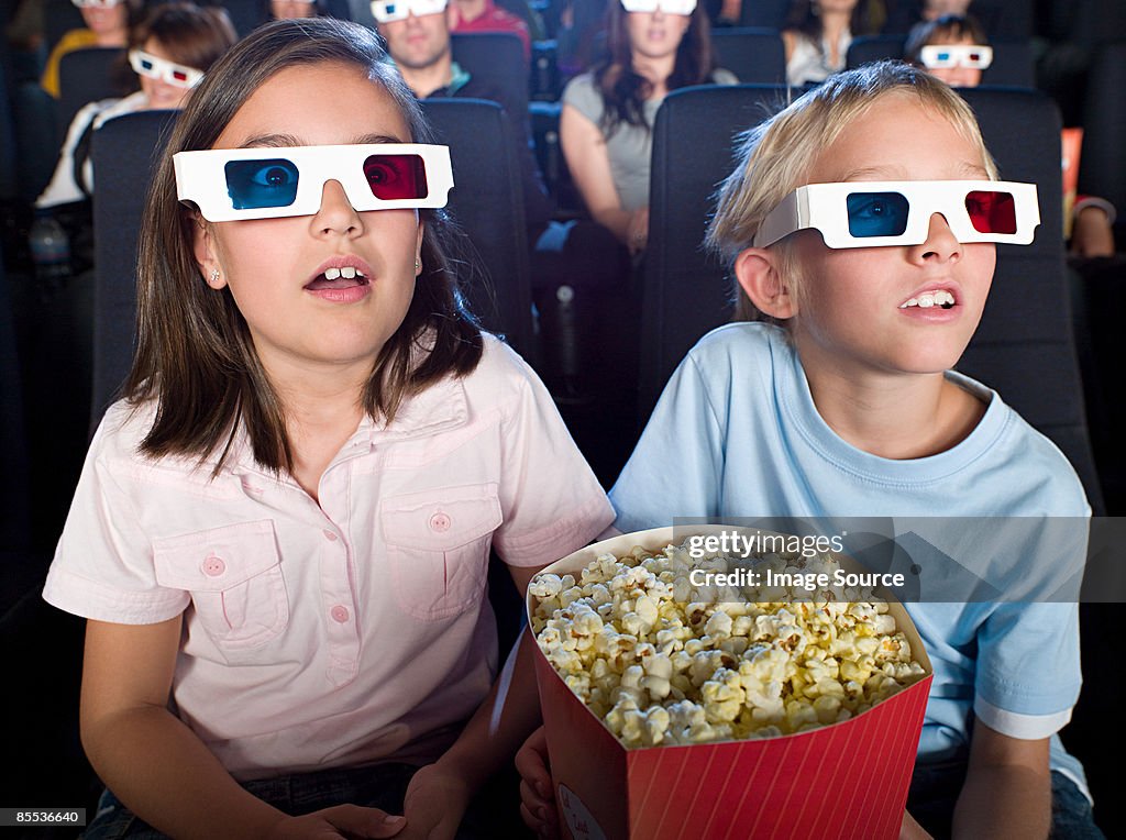 Boy and girl watching a 3d movie