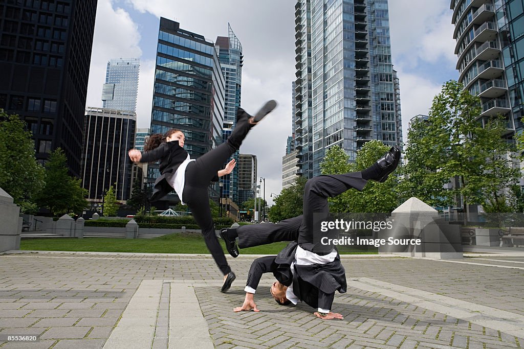 Businesspeople practising capoeira
