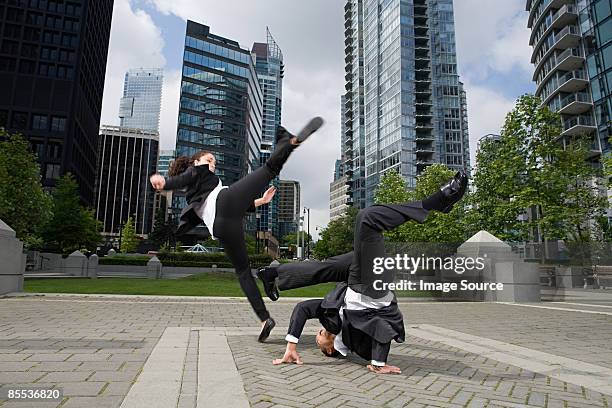 businesspeople practising capoeira - businesswoman handstand stock-fotos und bilder