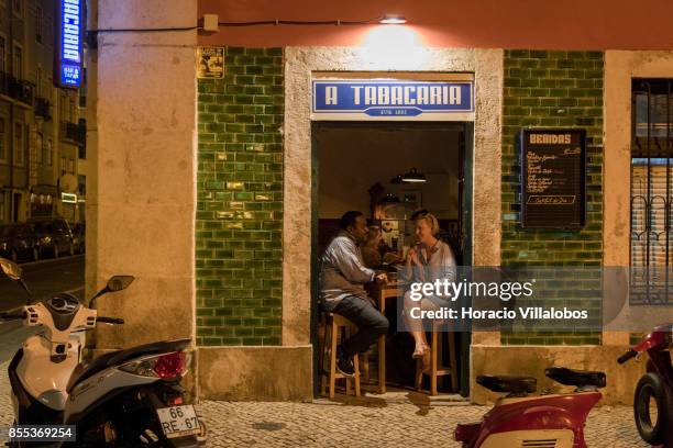 Clients enjoy a drink at "A Tabacaria", a bar established in 1885 in the historic neighborhood of Bica, on September 27, 2017 in Lisbon, Portugal....