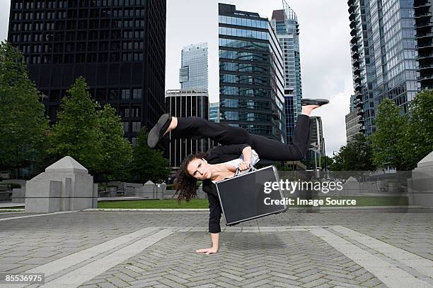 businesswoman practising capoeira - businesswoman handstand stock pictures, royalty-free photos & images