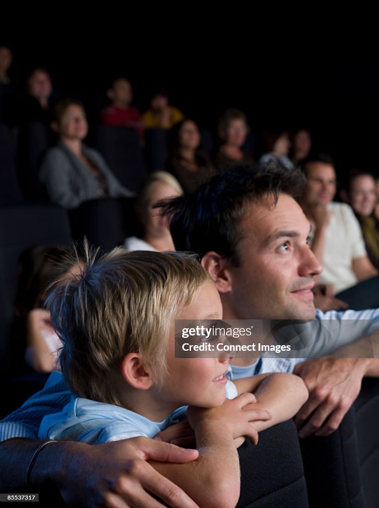 A father and son watching a movie