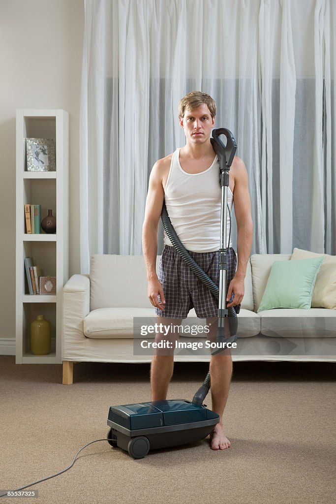 Portrait of a man with a vacuum cleaner