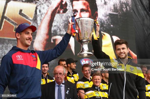 Trent Cotchin of the Tigers shows the Premiership Cup to the crowd as Damien Hardwick, coach of the Tigers looks on during the 2017 AFL Grand Final...