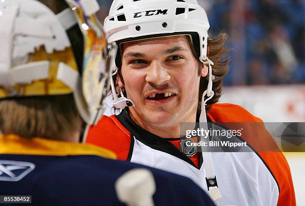 Daniel Carcillo of the Philadelphia Flyers smiles while chatting with Mikael Tellqvist of the Buffalo Sabres before their game on March 20, 2009 at...