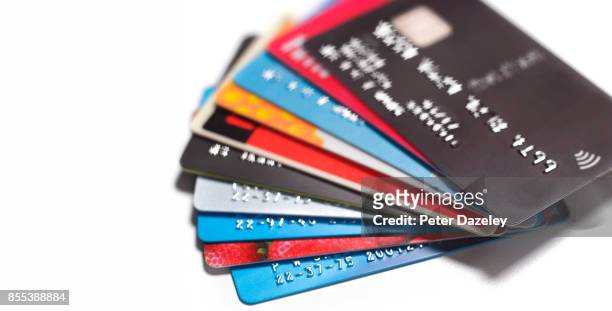 pile of credit cards - credit card stock-fotos und bilder