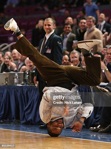 Actor Anthony Anderson breakdances to entertain the crowd during a timeout in the game between the Sacramento Kings and the New York Knicks on March...