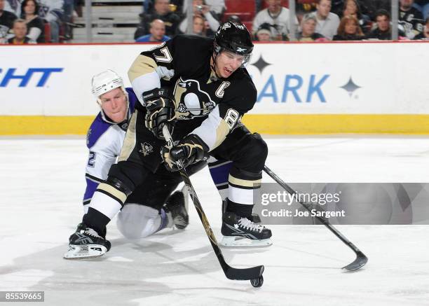 Sidney Crosby of the Pittsburgh Penguins controls the puck in front of the defense of Matt Greene of the Los Angeles Kings on March 20, 2009 at...