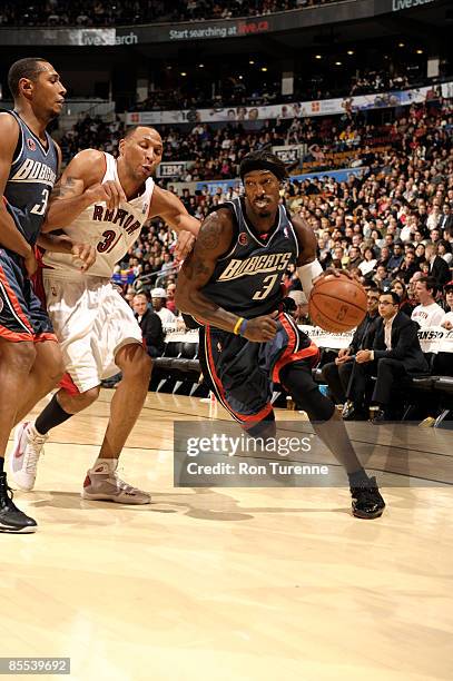 Gerald Wallace of the Charlotte Bobcats drives the baseline past Shawn Marion of the Toronto Raptors during a game on March 20, 2009 at the Air...