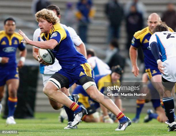 Adam Thomson of the Highlanders makes a break during the round six Super 14 match between the Highlanders and the Cheetahs at Carisbrook on March 21,...