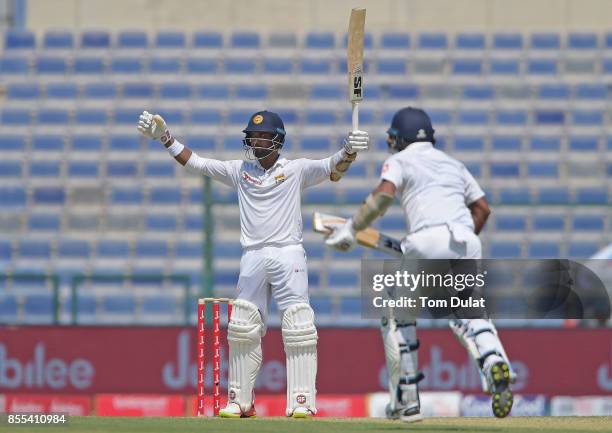 Dinesh Chandimal of Sri Lanka celebrates reaching his century during Day Two of the First Test between Pakistan and Sri Lanka at Sheikh Zayed Stadium...